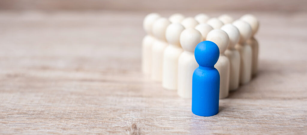 blue leader businessman with crowd of wooden men. leadership, business, team, teamwork and Human resource management concept